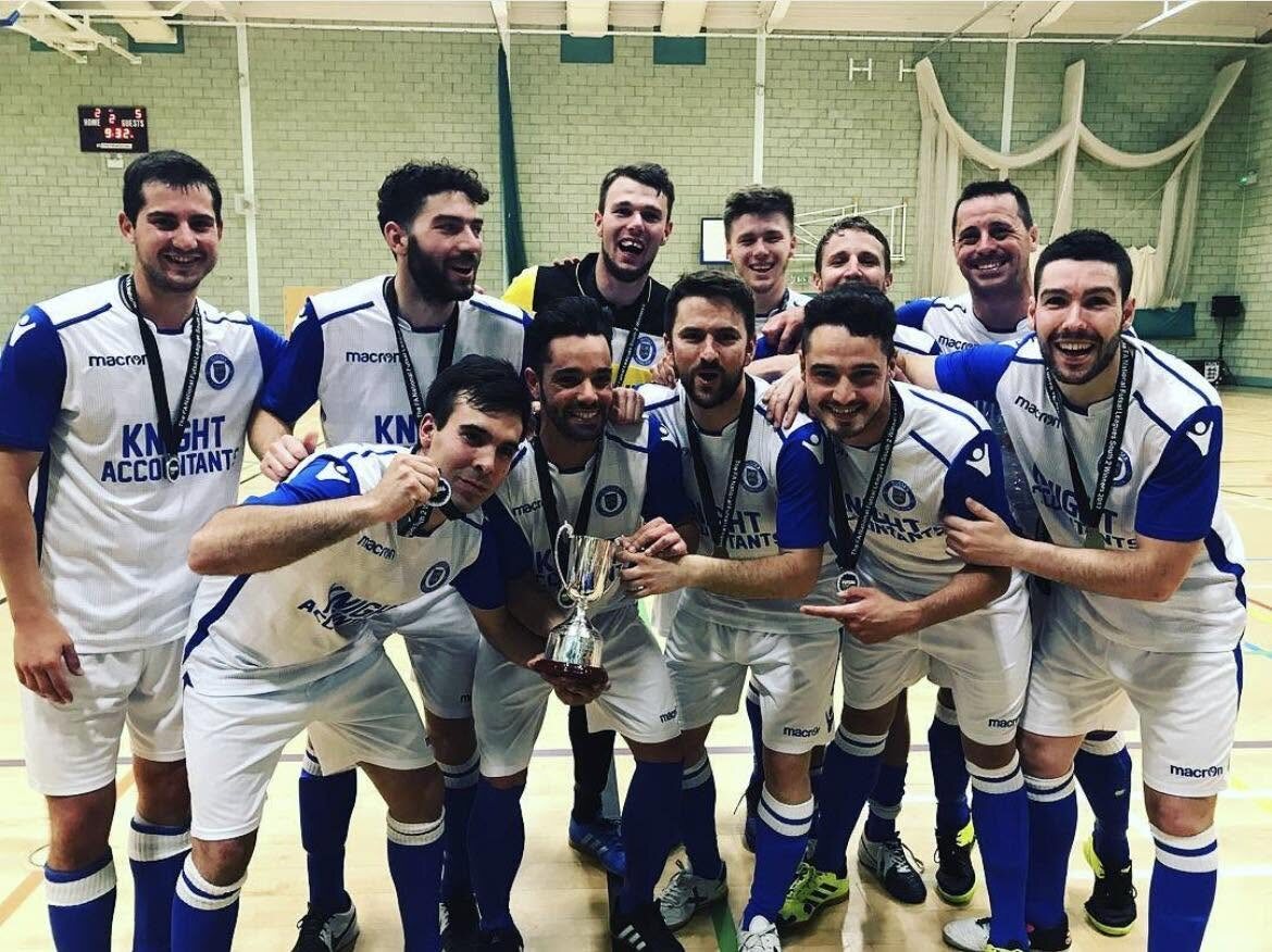 Sussex Futsal players celebrating with a trophy